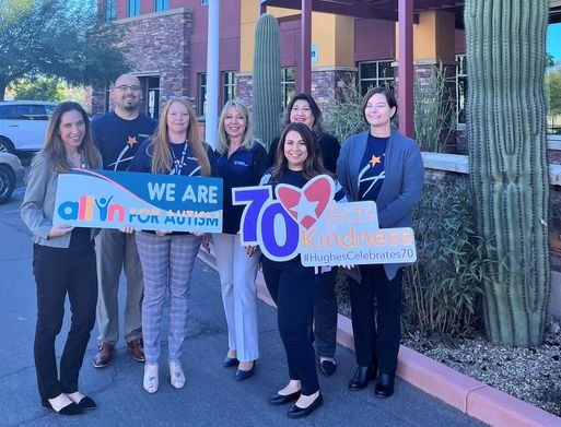 The Hughes team and Banner Health Foundation team pose for photo holding signs