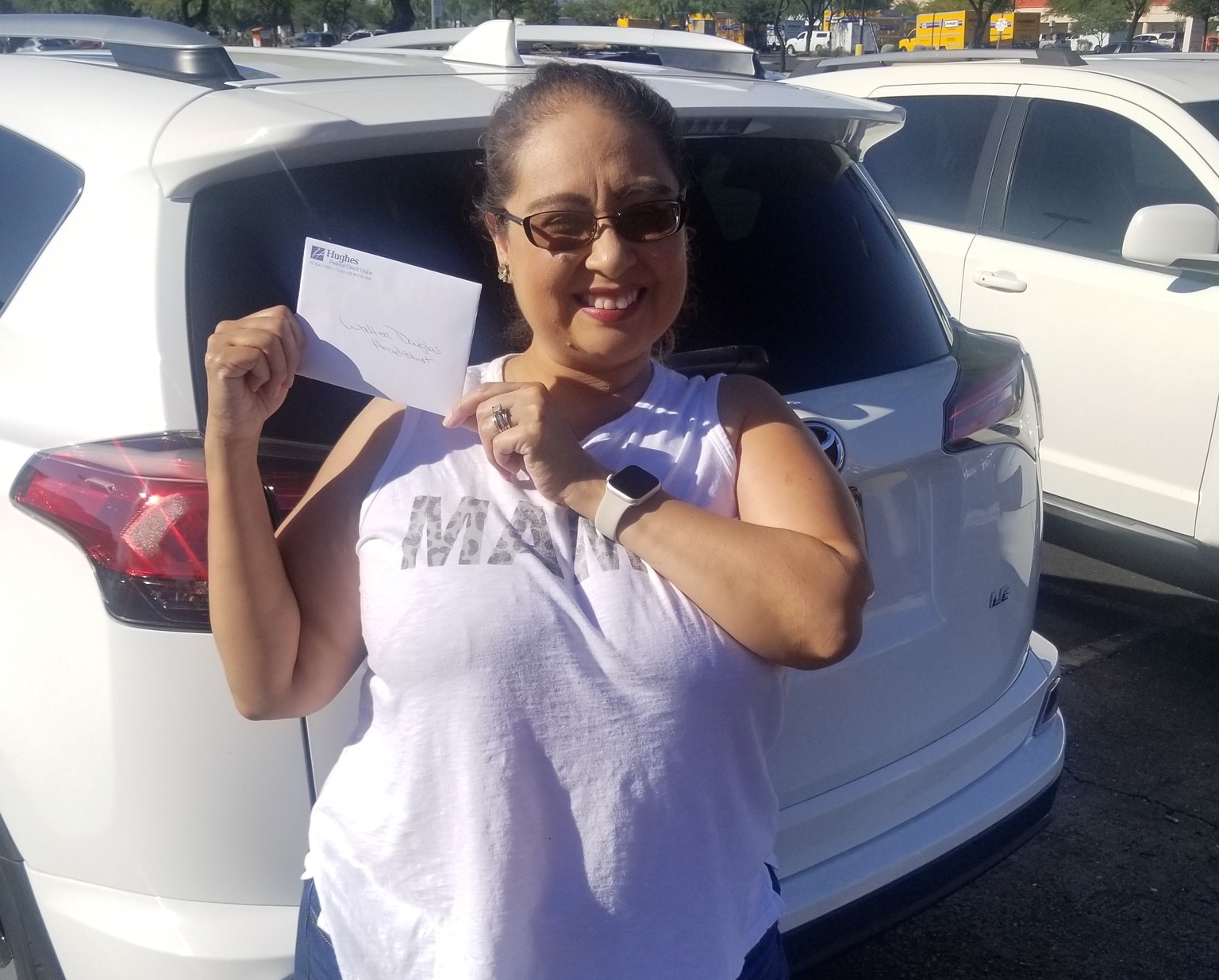 Teacher maria holds up gift card