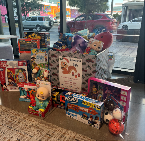 A box filled with toys surrounded by additional toys