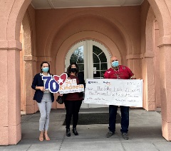The Hughes team and the VA staff pose with a check