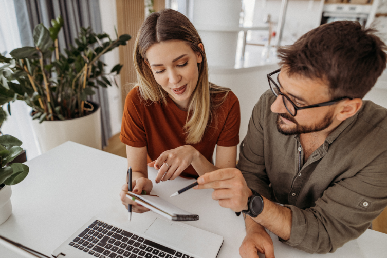 A couple at home using a laptop.