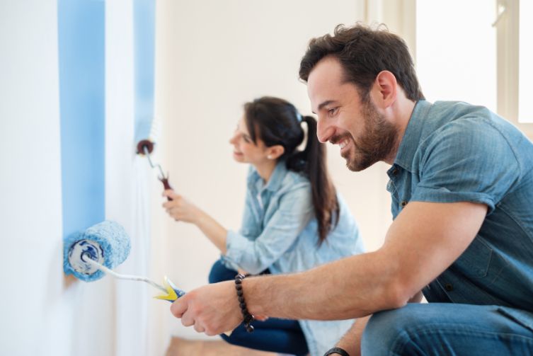 Couple paints walls of home with blue paint