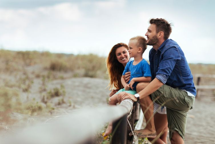 Young parents relaxing with their son as they look out to the desert.