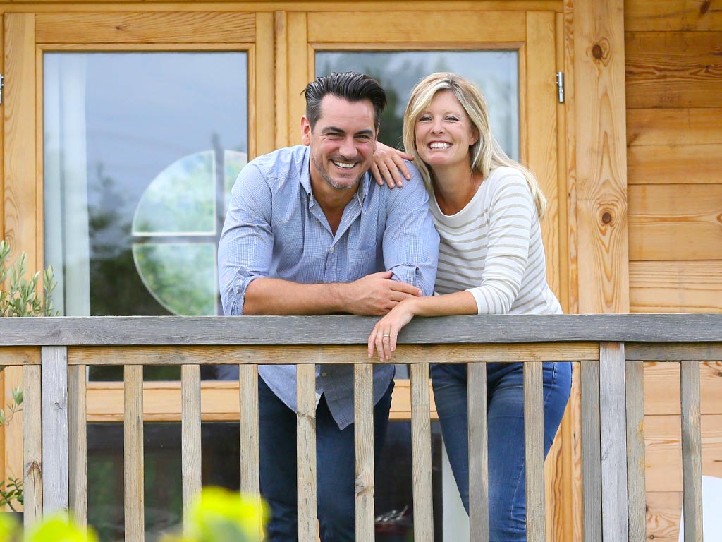 Couple smiling on cabin balcony