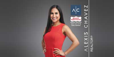 Smiling woman in red top with hands on her hips, Realty Executives logo