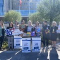 Group with donations in front of hospital.