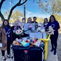 Hughes and hospital staff with toy donation.